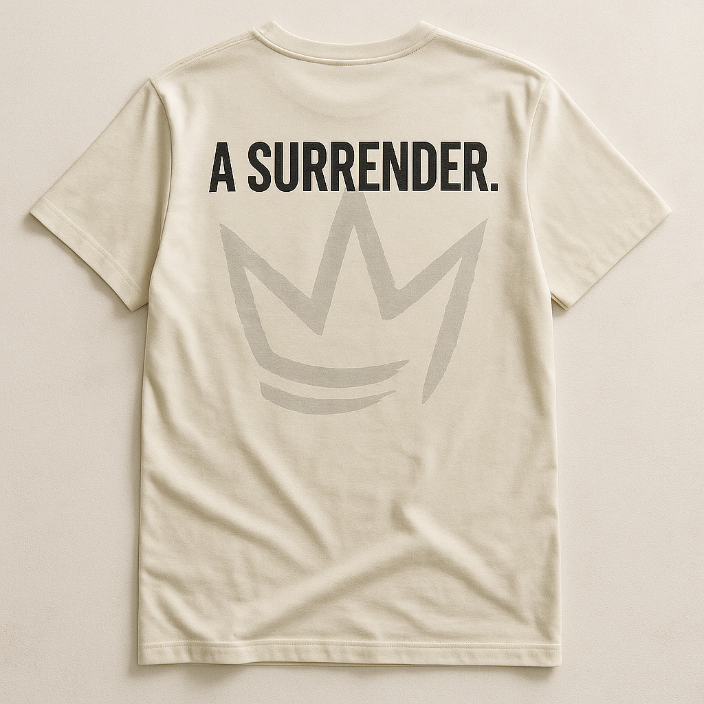 The Confession Tee back flat lay showing A SURRENDER. message over ghosted crown graphic